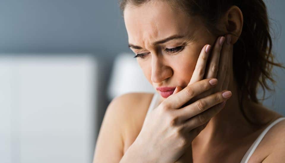 Female experiencing dental pain